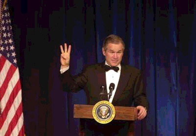 President George W. Bush holds up three fingers