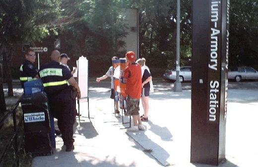 Three fans try to get All-Star displays past Metrorail security.