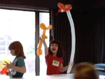 Miranda doing a puppet show with ballons