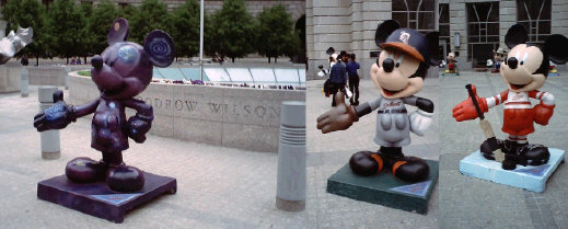 Tom Hanks model in front of Woodrow Wilson Plaza engraving. Mickeys in Detroit Tigers and Red Wings uniforms.