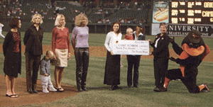 Oriole wives presenting a check for Camp Sunrise.