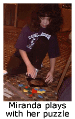 Miranda plays with her puzzle