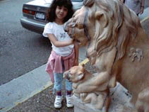 Miranda putting her hand in the mouth of a realistic lion