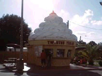 A small store in the shape of a soft ice cream cone