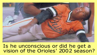 Daniel E. Smith as the unconscious Mike Archibald in the film 'John Q'. He's wearing an Orioles jersey. The text reads,'Is he unconscious or did he get a vision of the Orioles' 2002 season?' I'm milking this Orioles placement for all it's worth.